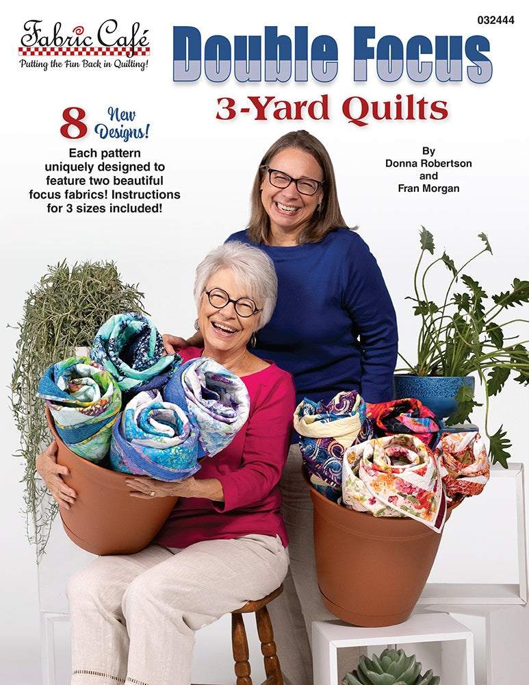 Double Focus 3-Yard Quilts book by Fabric Cafe with two women holding colorful fabric rolls for quilting