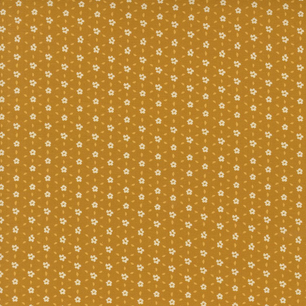 Sagewood by Crystal Manning Seedling Golden Ditsy fabric with small white floral pattern on golden background