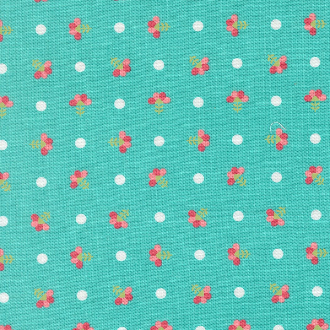 In the Garden Dotted Sprig Bermuda fabric with turquoise background, red floral sprigs, and white dots by Corey Yoder for Moda Fabrics