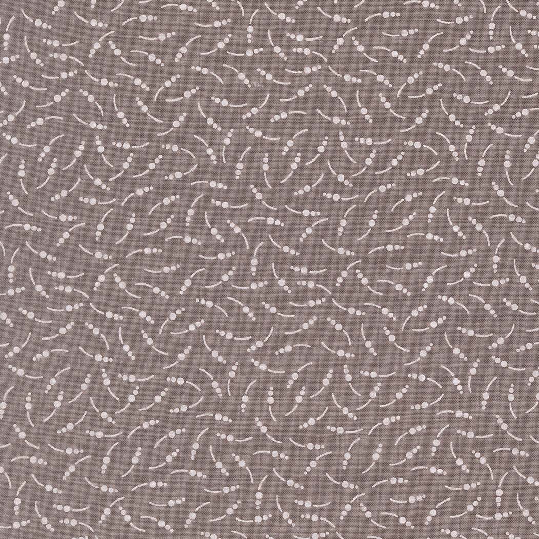 In the Garden Sugar Snap Slate fabric by Corey Yoder with white floral dots on slate background