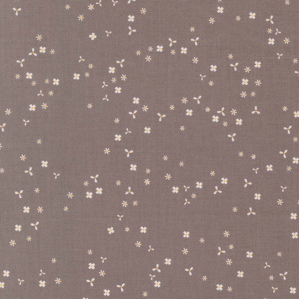 In the Garden Flutter Slate fabric by Corey Yoder with small white floral pattern on slate gray background