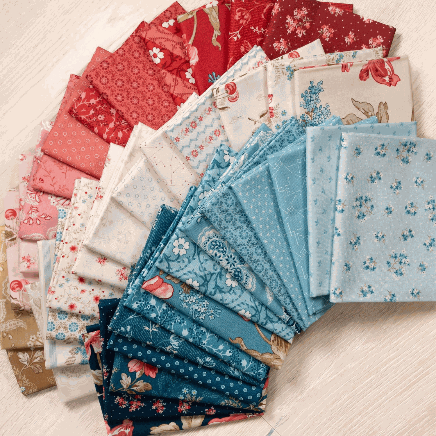 36-piece Lighthouse Fat-Quarter Bundle with vibrant florals in red, blue, and cream tones by Edyta Sitar