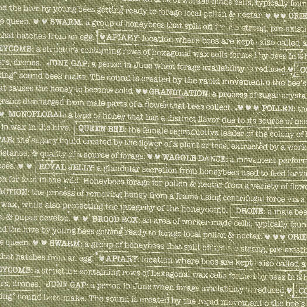 Close-up view of Wild Honey Buzz Words Fern fabric by Lella Boutique featuring bee and honeycomb text design in warm golden hues