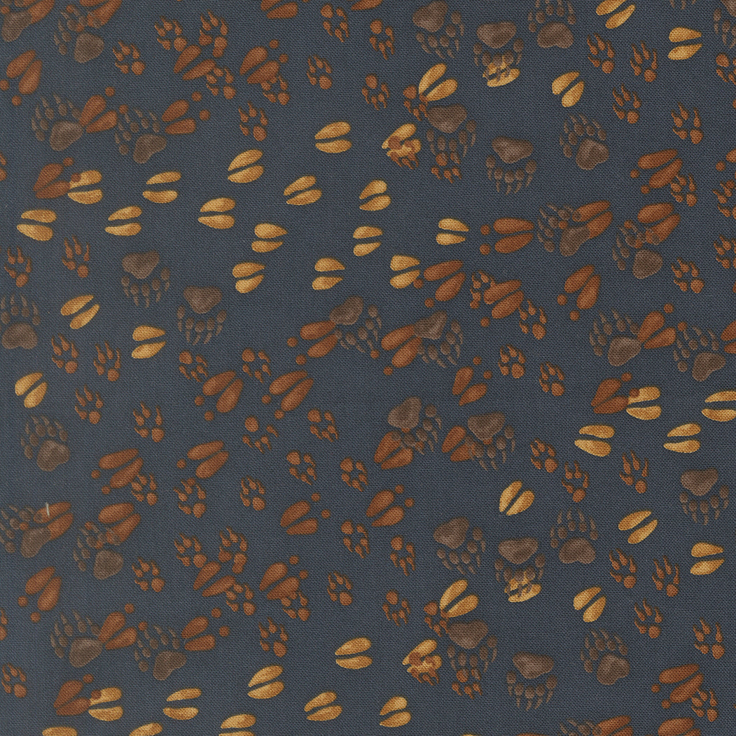 Northwoods Lodge fabric by Deb Strain featuring animal tracks and pine trees in midnight colors