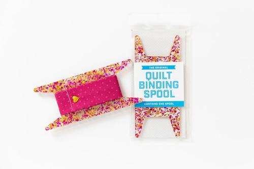 Pink and gold Gliter Binding Spool for organizing quilt bindings, 5.75 by 2.5 inches