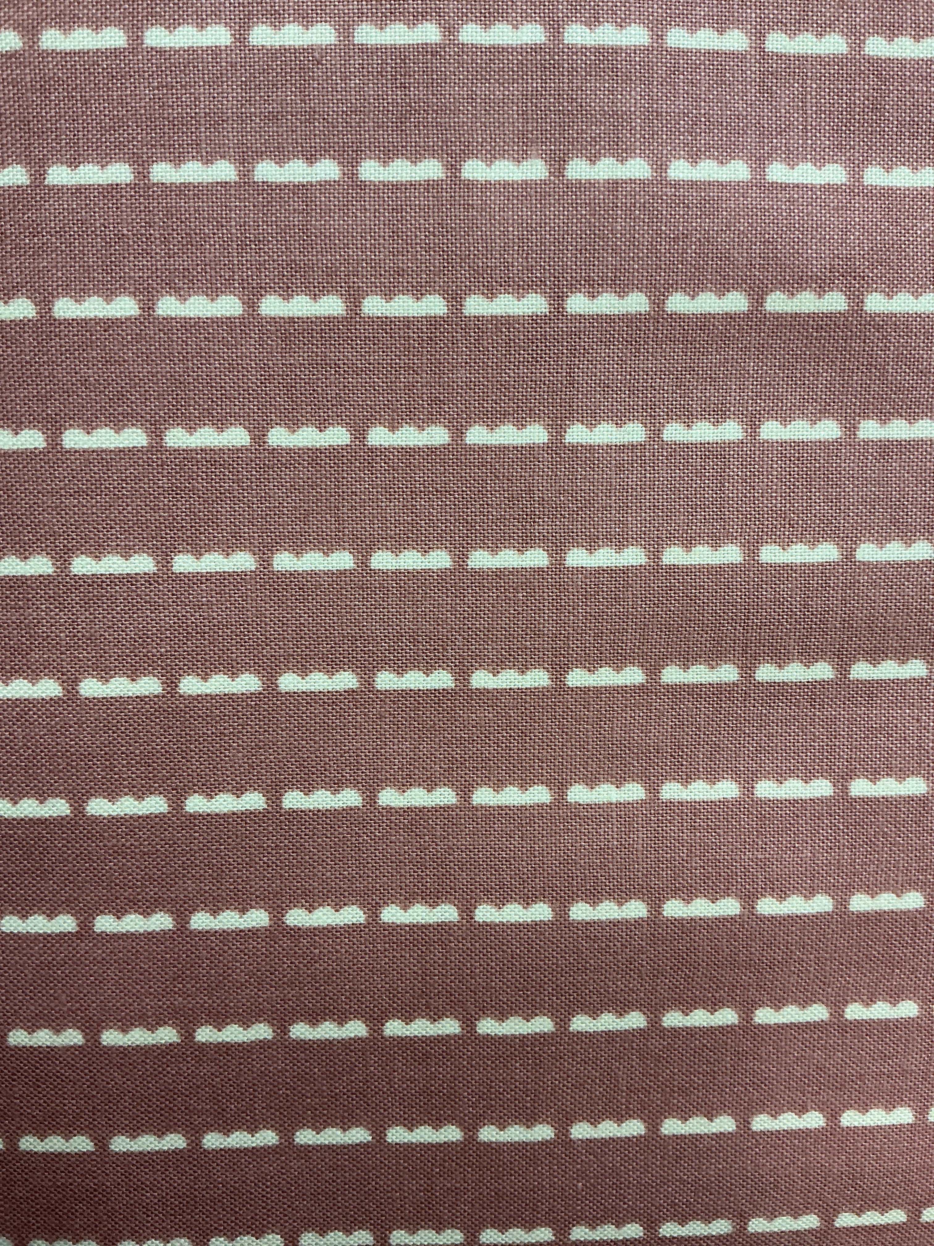 Bundle of colorful 5-yard fabric cuts for sale on display