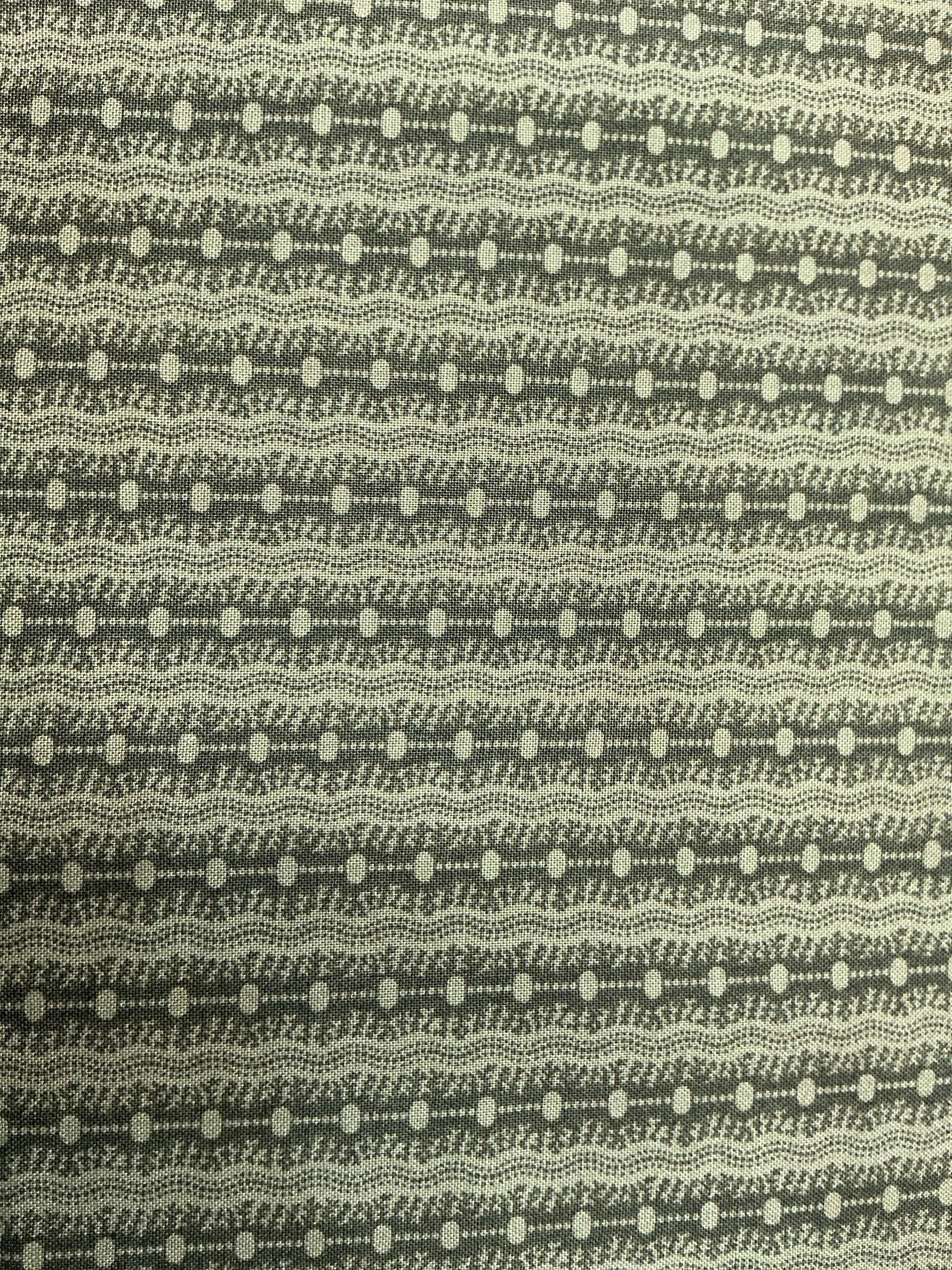 Rolls of 5-yard fabric cuts on sale stacked in a store