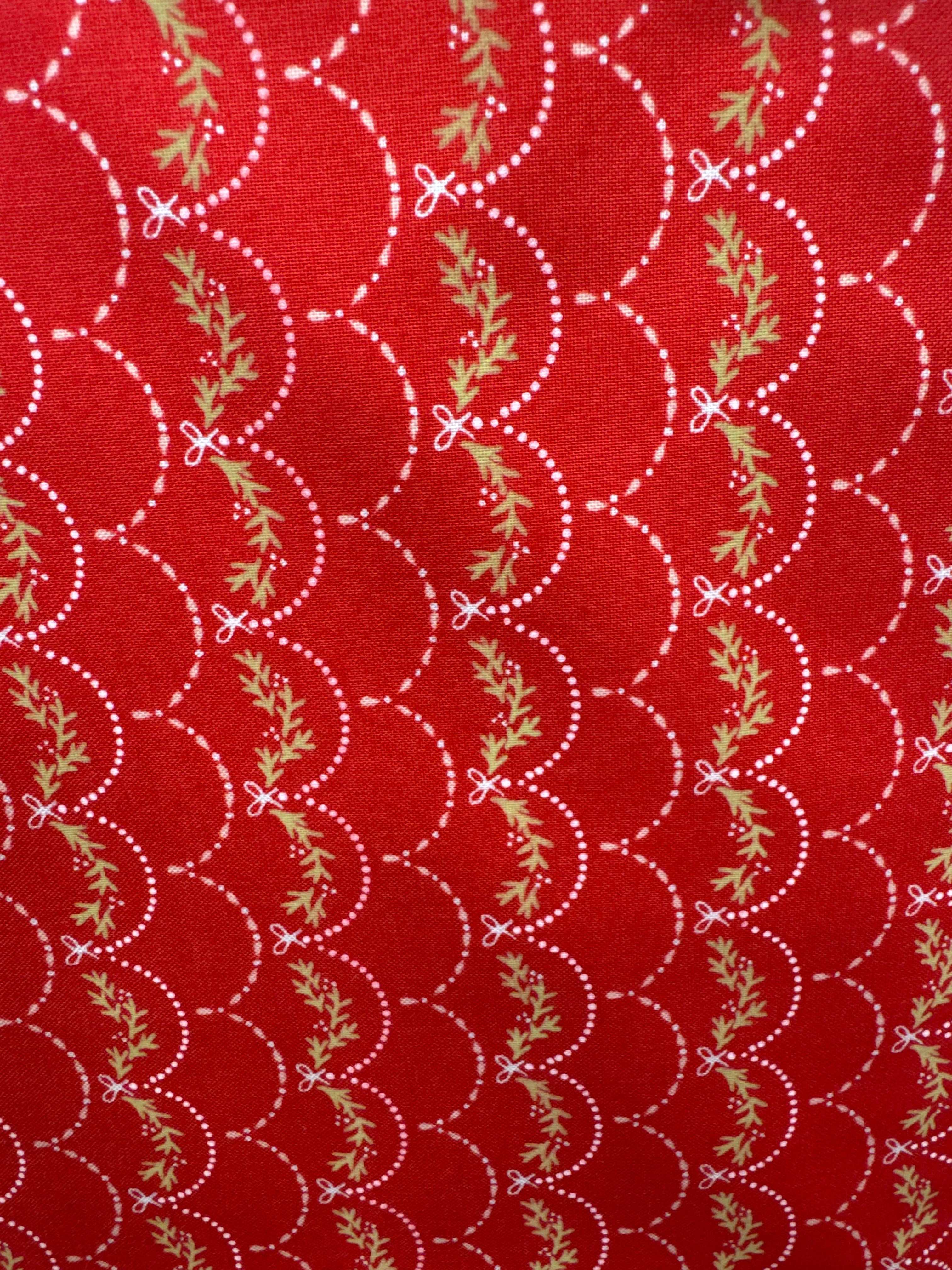 Joyful Joyful red fabric with white dotted scallop pattern and green leaf accents sold by half yard