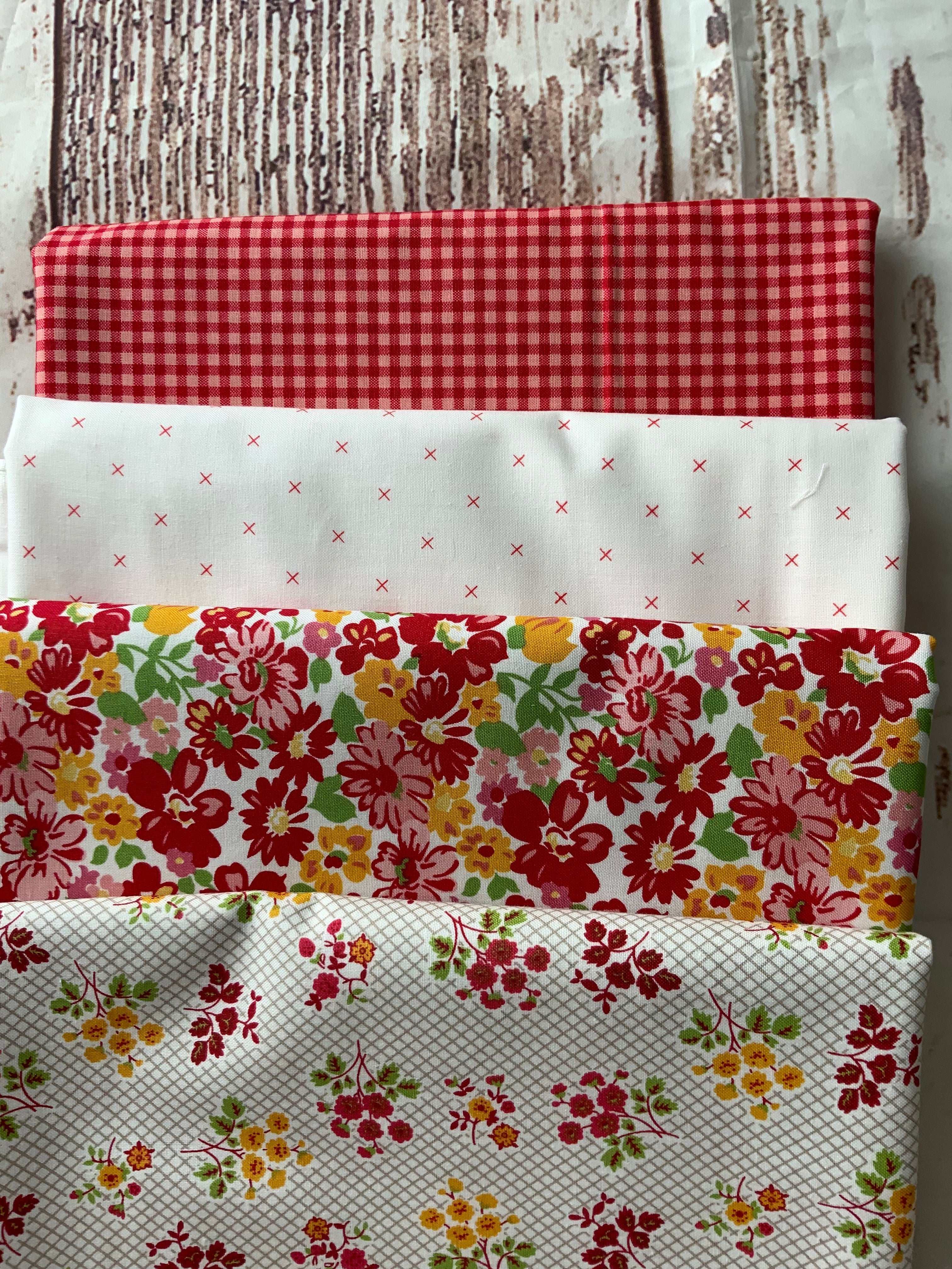 4-yard quilt kit fabric bundles with red checks, white with red crosses, and floral patterns