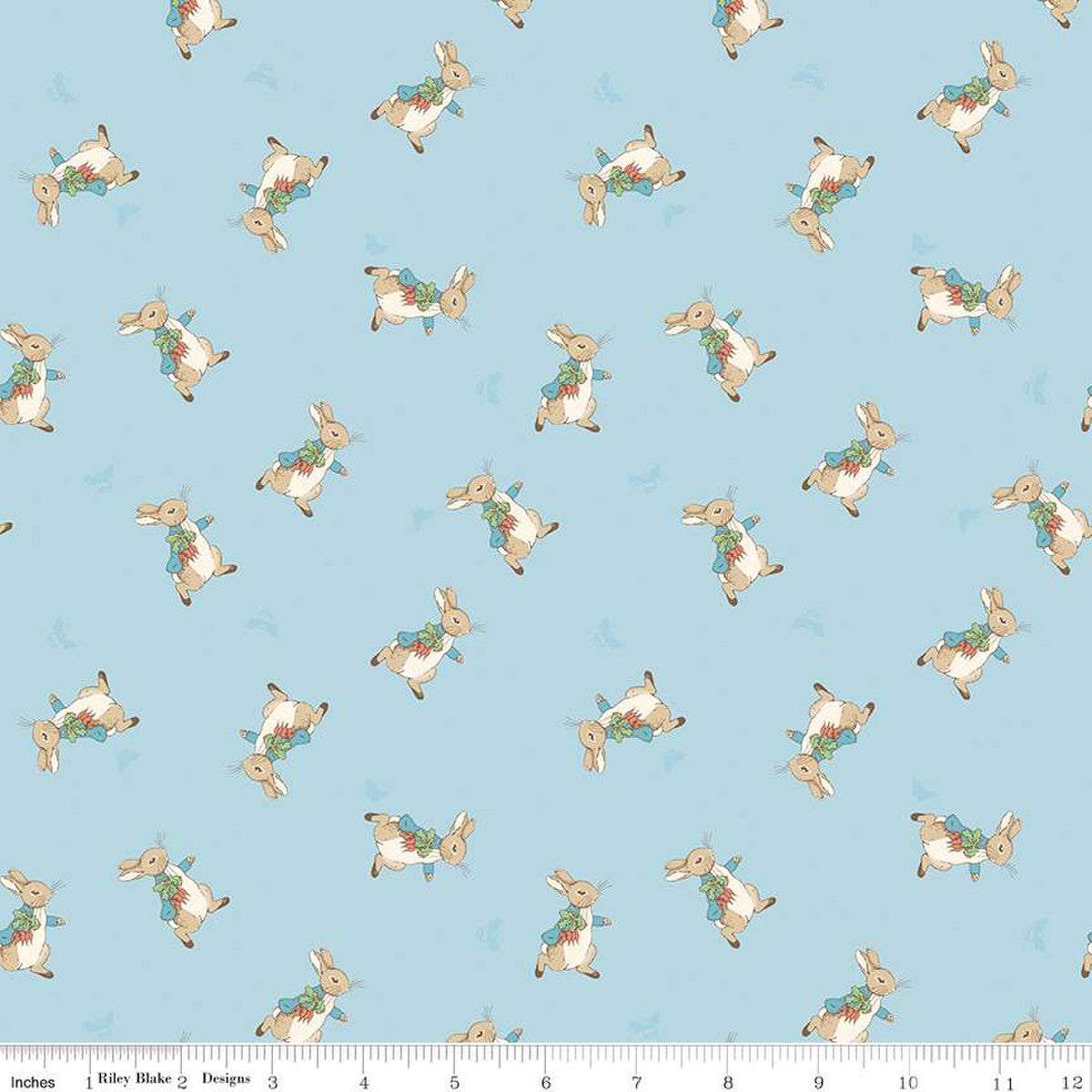 The Tale of Peter Rabbit fabric with tossed Peter Rabbit illustrations on blue background by Riley Blake Designs