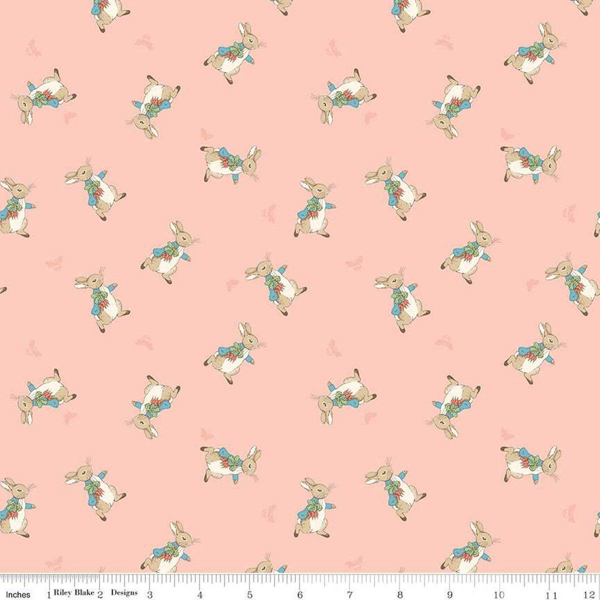 The Tale of Peter Rabbit fabric with tossed Peter Rabbits on coral background for quilting and decor