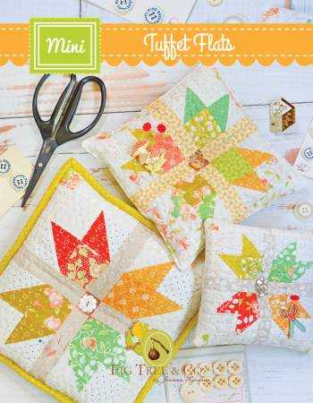 Tuffet Flats Quilt Pattern pincushions with colorful patchwork designs and sewing accessories.