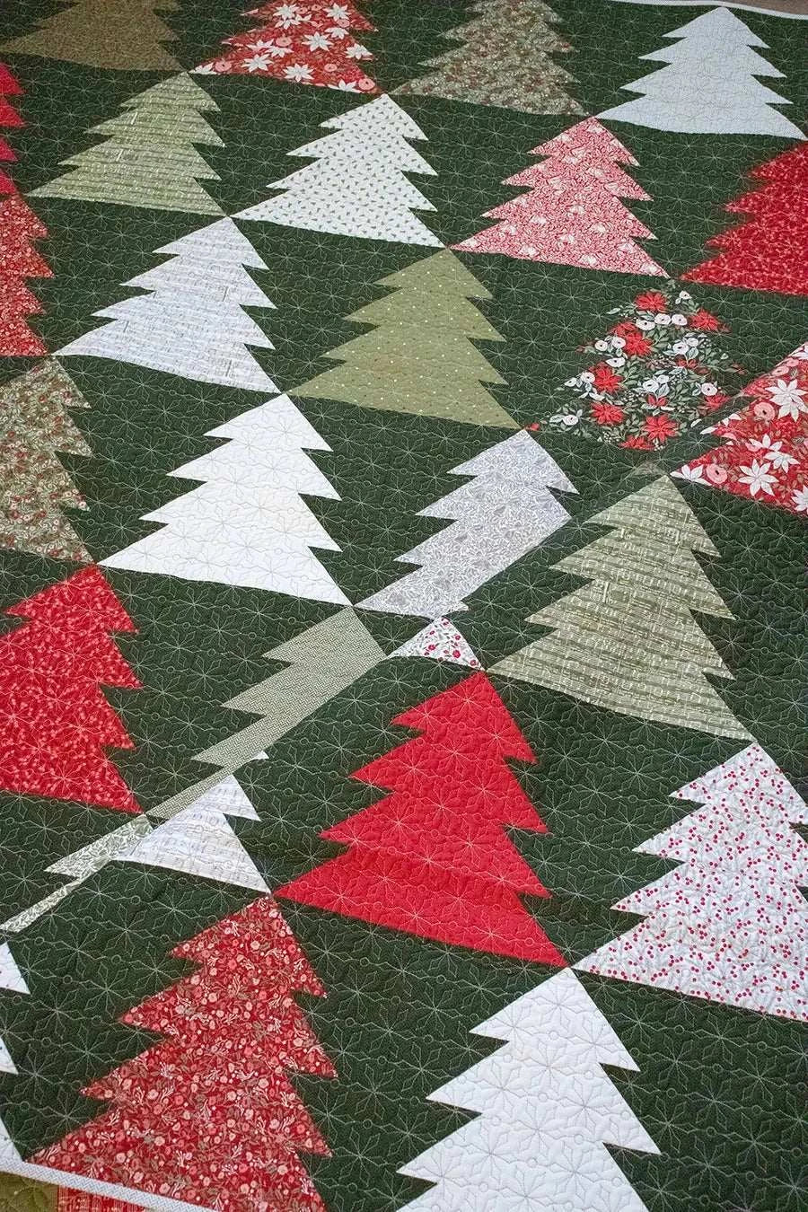 Fir Tree Lane Quilt Kit with Berry & Pine fabric featuring red, green, and white Christmas tree patterns on dark green background