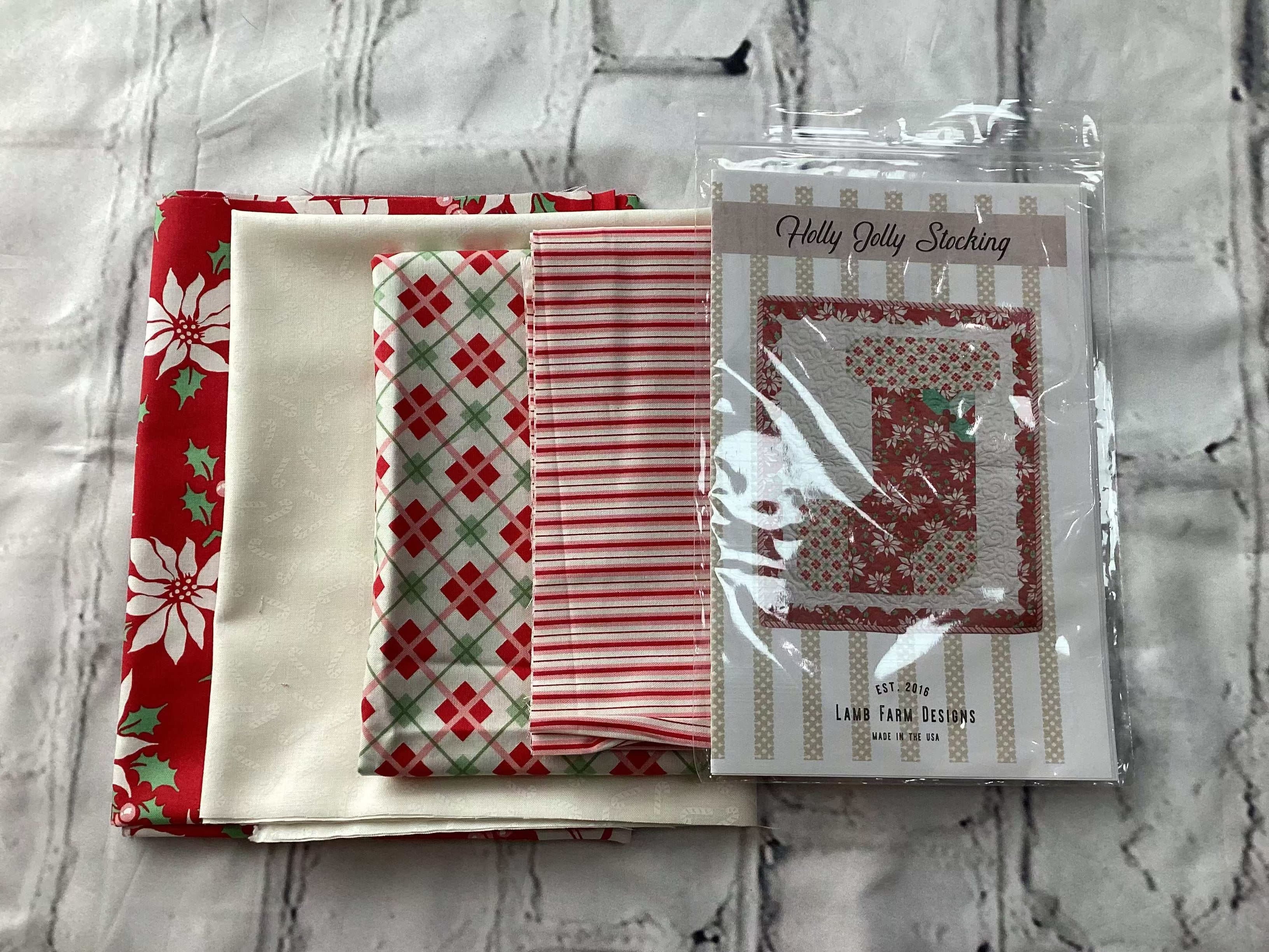 Holly Jolly Stocking kit with red, white, and plaid fabric pieces for Christmas crafting