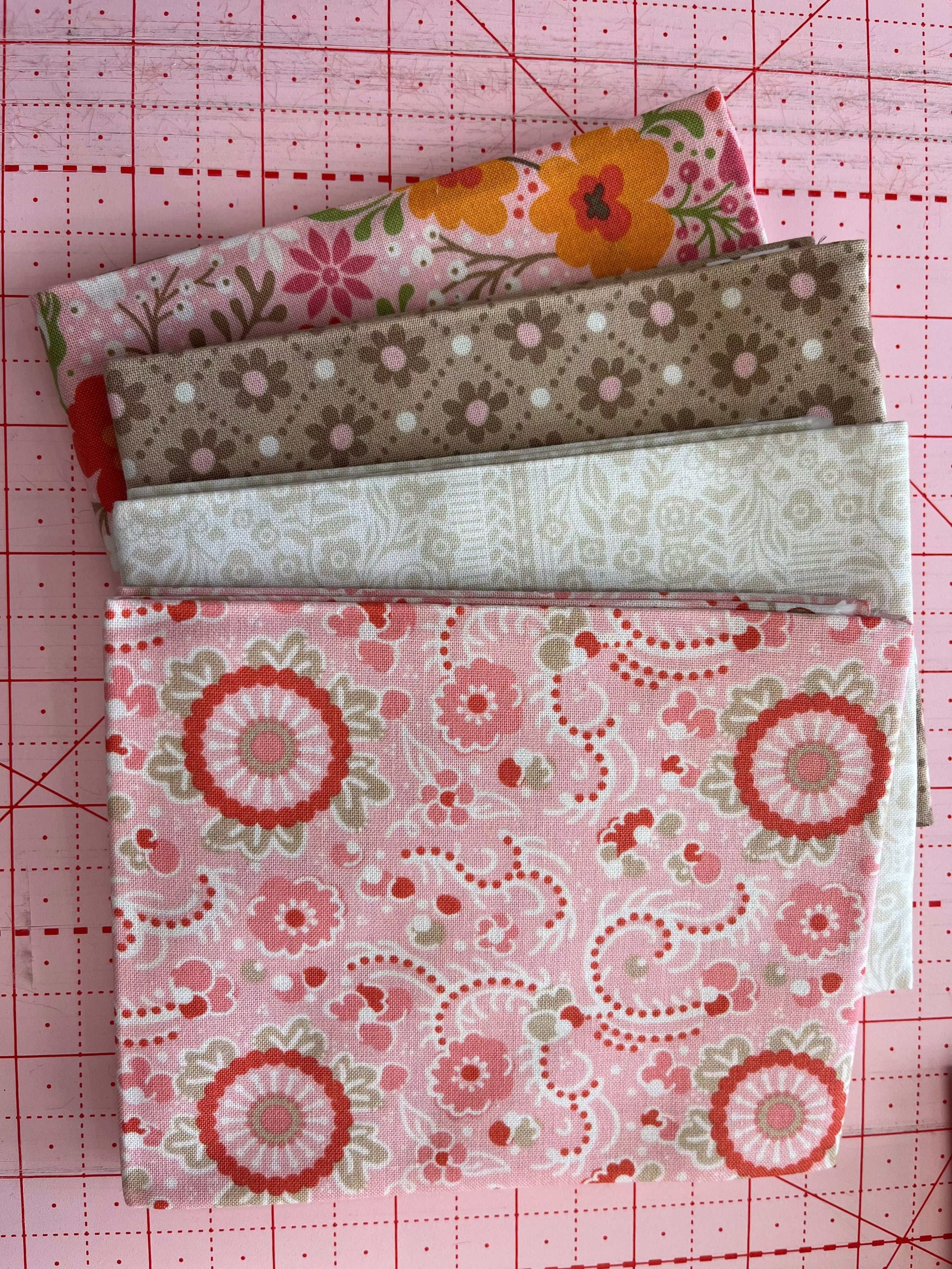 4-Yard Quilt Kit with floral and patterned fabric bundles on cutting mat