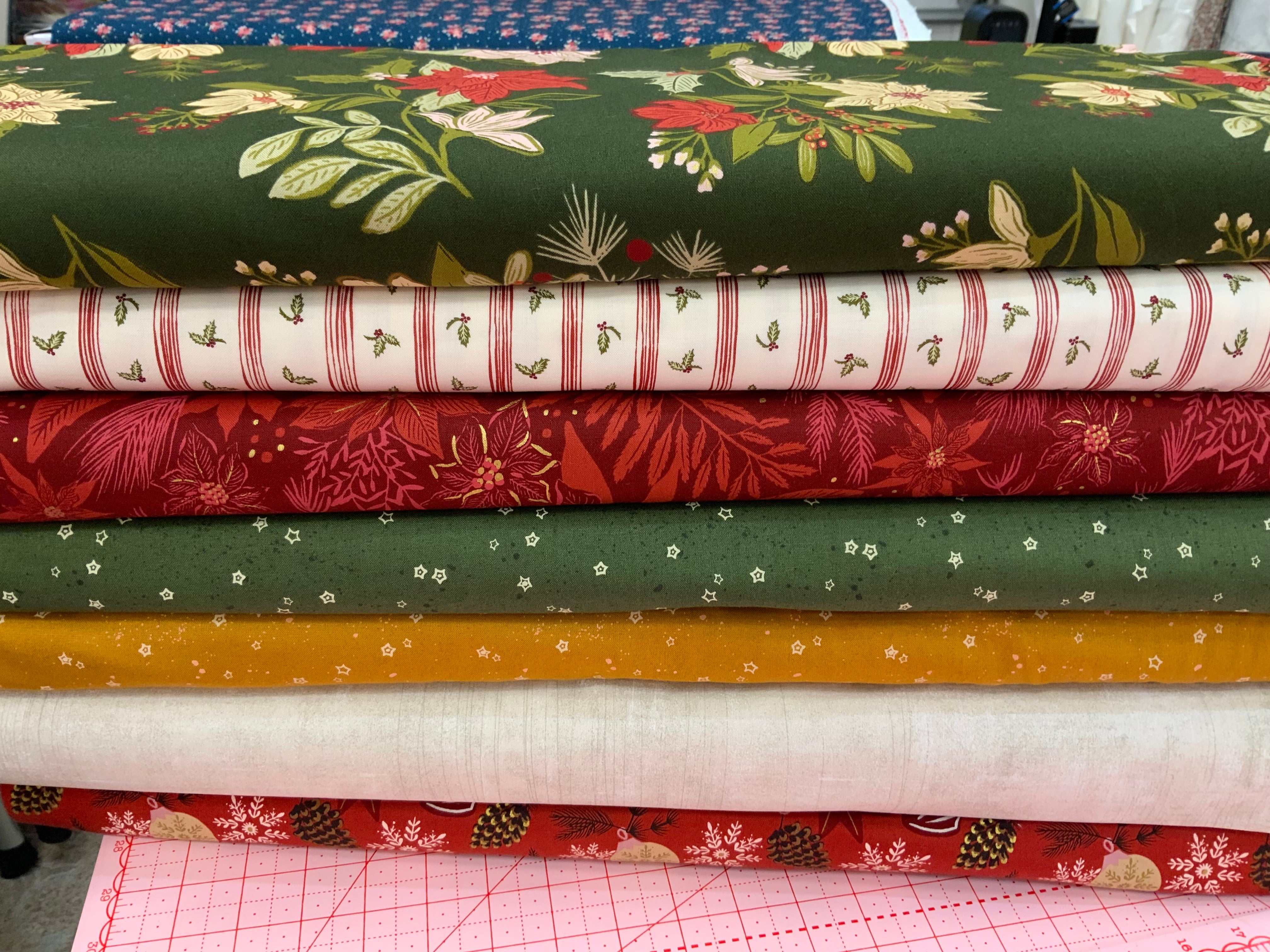 M50 Island Hopping Kit fabric stack with floral and striped quilting cottons for mystery quilt project