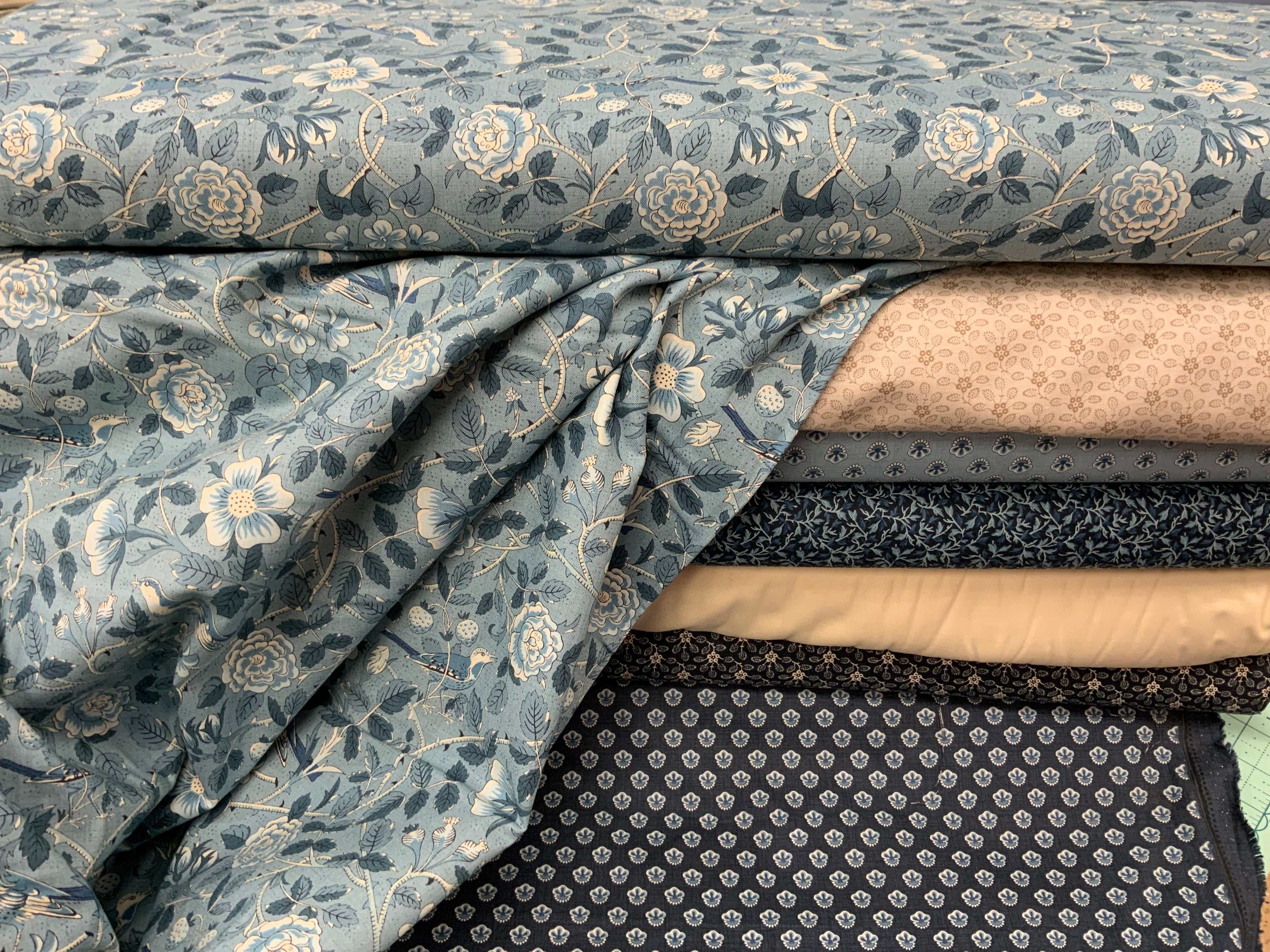 M50 Island Hopping Kit with assorted blue and beige floral and patterned quilting fabrics