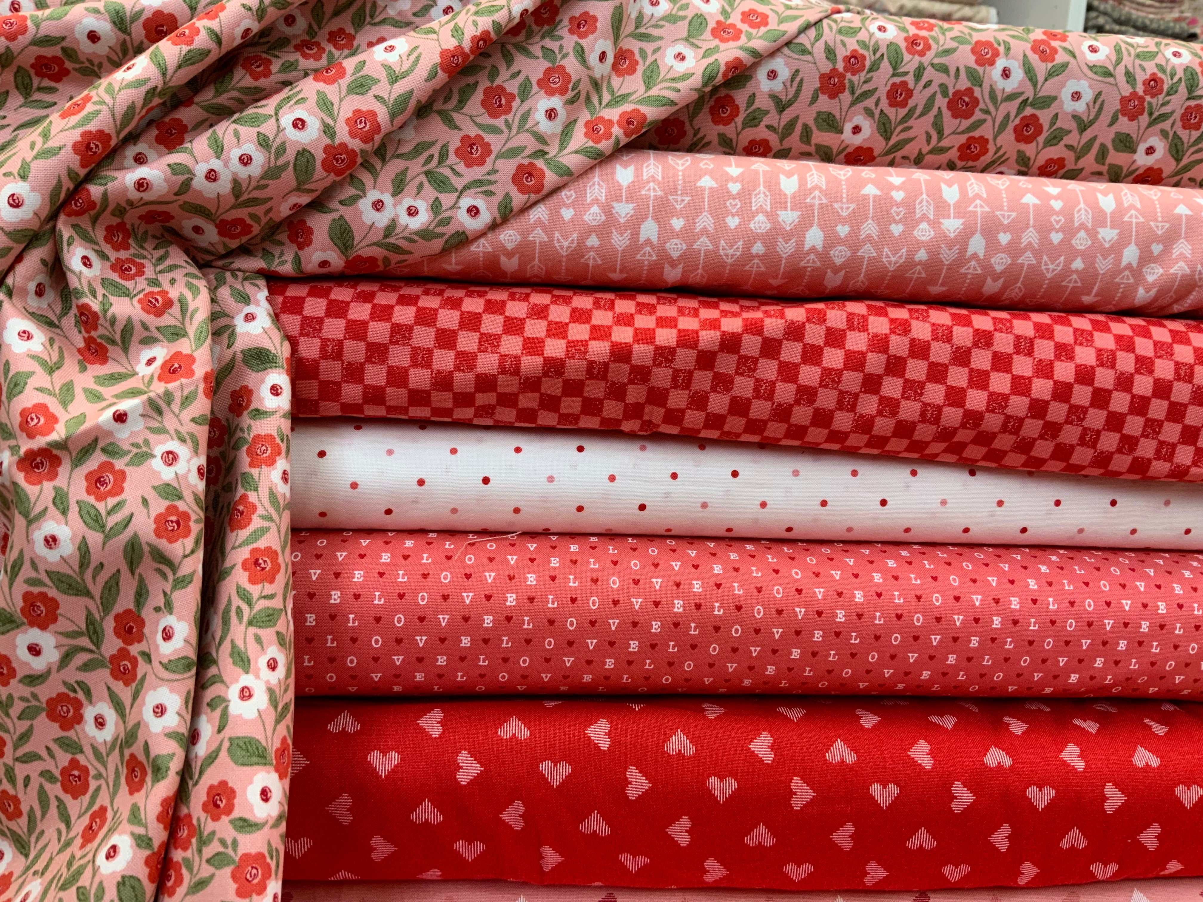 M50 Island Hopping Kit fabric bundle with red, pink, and floral quilting fabrics curated by Bella Rose Quilts