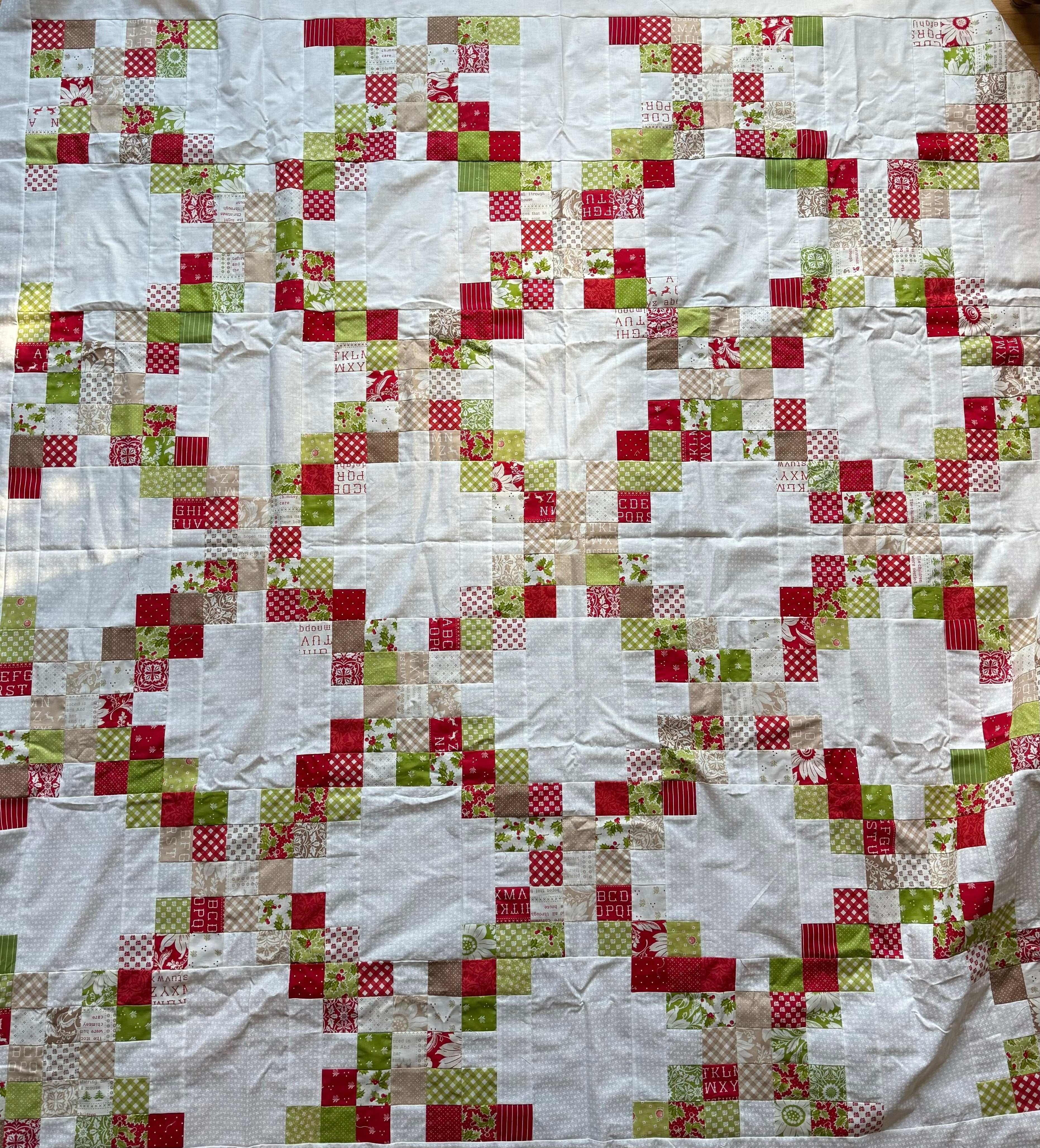 Chain of Fools Quilt Kit with Christmas Stitched fabric in red, green, and white patchwork design