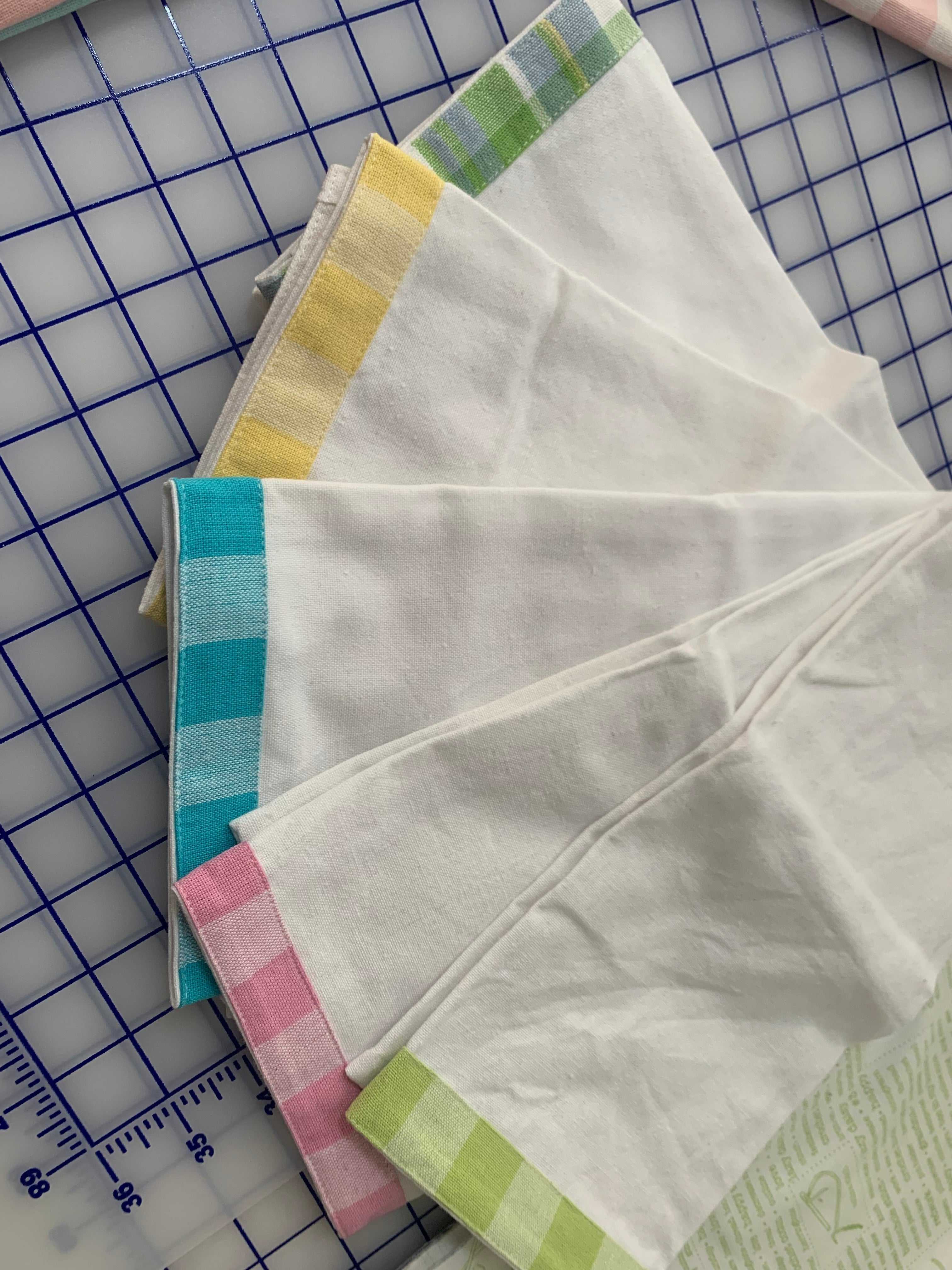 Set of kitchen towels with vintage gingham trim in pastel colors on white cotton fabric