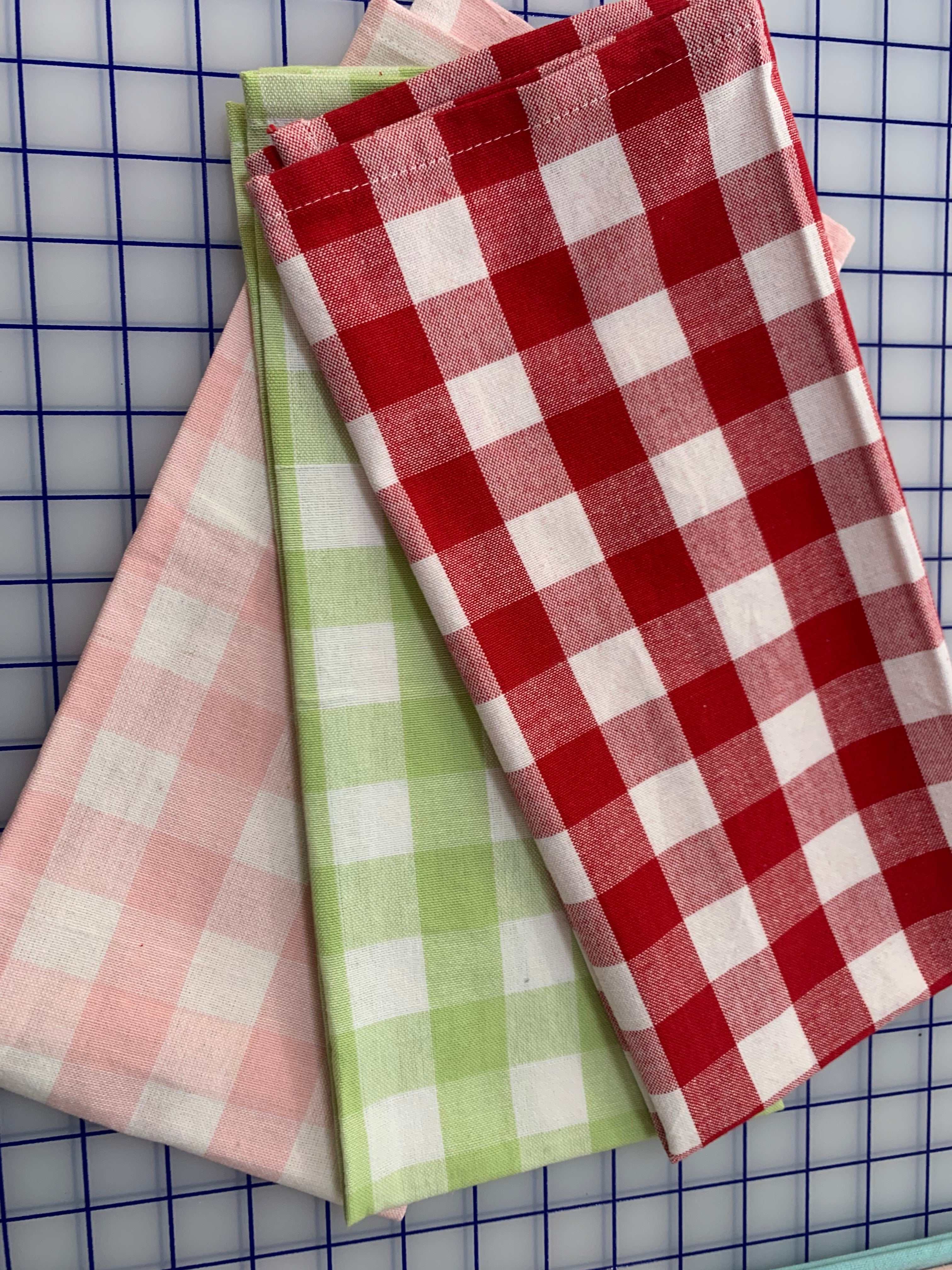Pastel buffalo check kitchen towels in pink, spring green, and red cotton designs