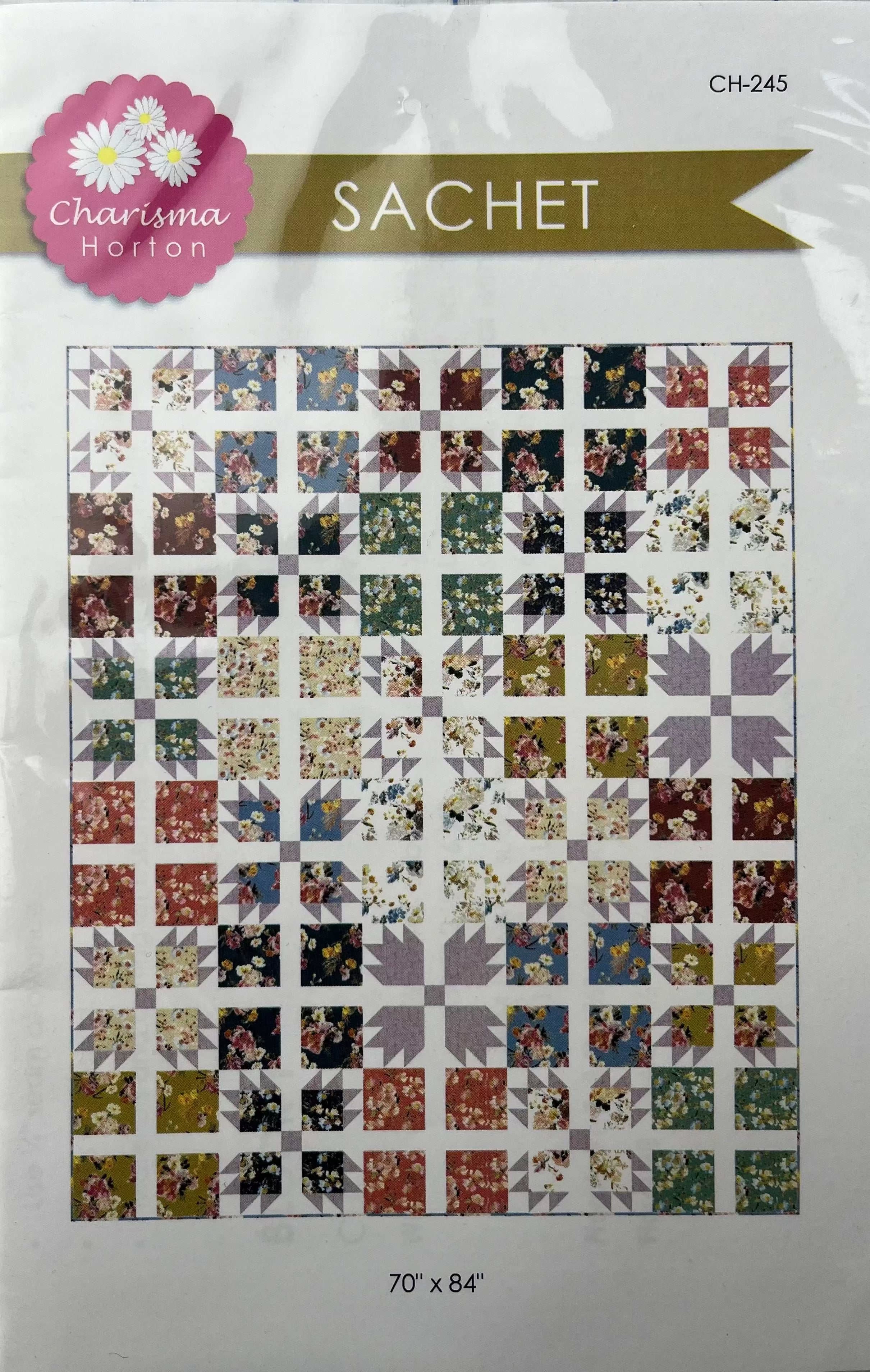 Sachet Pattern-Charisma Horton quilt design with floral and geometric blocks in multiple colors, 70" x 84"