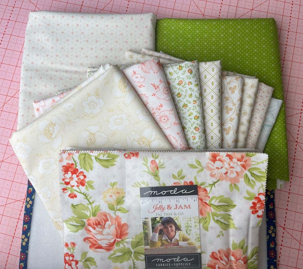 Orange Crush Quilt Kit fabrics by Fig Tree with floral and green prints curated by Bella Rose Quilts