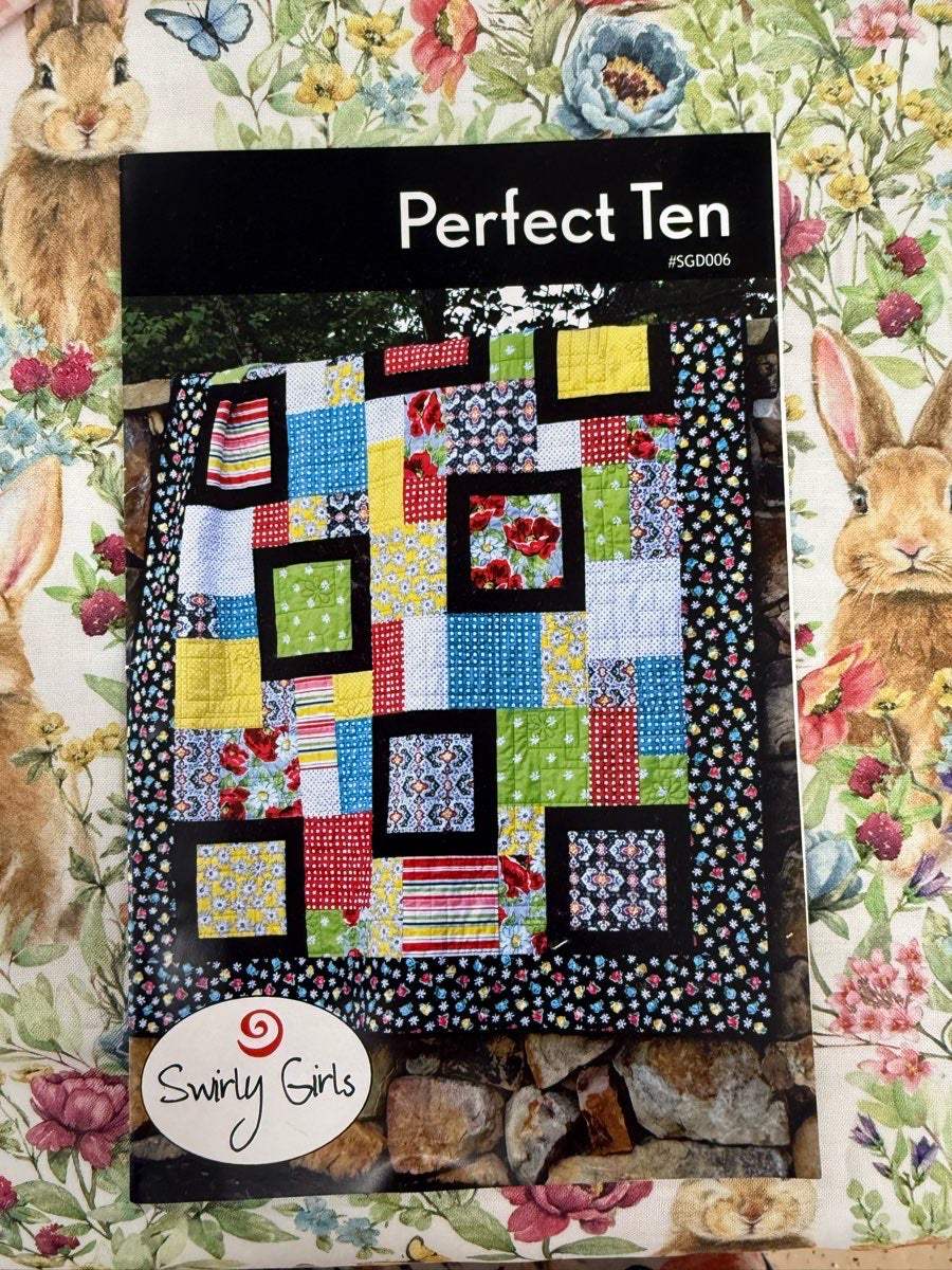 Colorful patchwork quilt with black borders from Perfect Ten Quilt Pattern by Swirly Girls Design