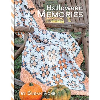 Halloween Memories quilt pattern book by Susan Ache featuring Halloween-themed orange, black, and purple quilt designs with pumpkins on rustic wooden bench