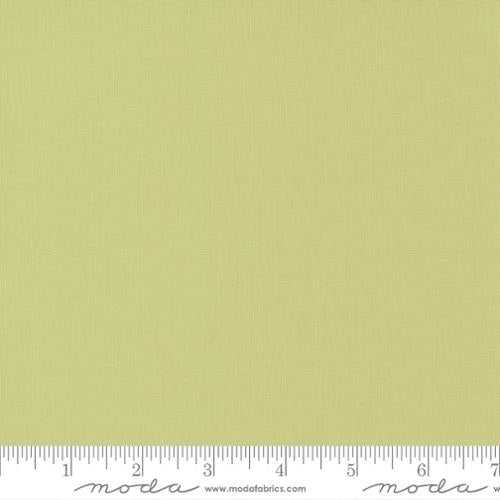 Moda Bella Solid fabric in celery green shade with measurement ruler at the bottom