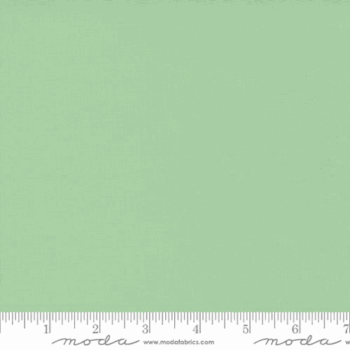 Bella Solids from Moda 9900 133 Mint fabric swatch with ruler for measurement