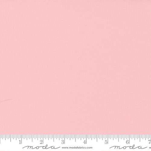 Bella Solids by Moda Fabrics 9900 145 Sisters Pink fabric sample with ruler