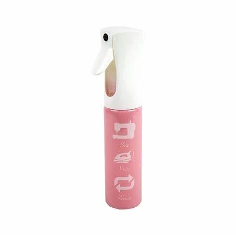 Pink Riley Blake Ultimate Fabric Mister spray bottle with white trigger and sewing-themed design