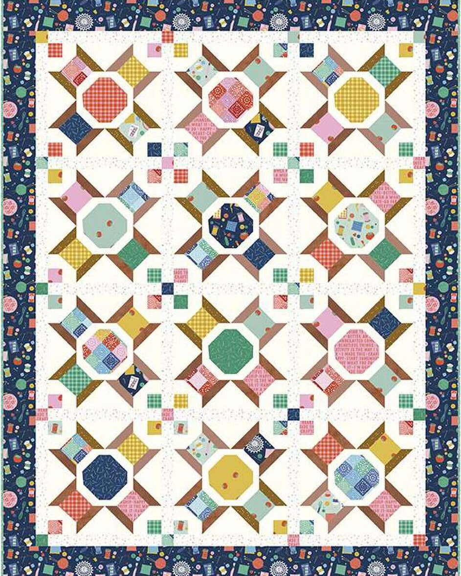 Vintage Spools Quilt Kit with colorful spool blocks and navy floral border by Amber Kemp-Gerstel for Riley Blake Designs