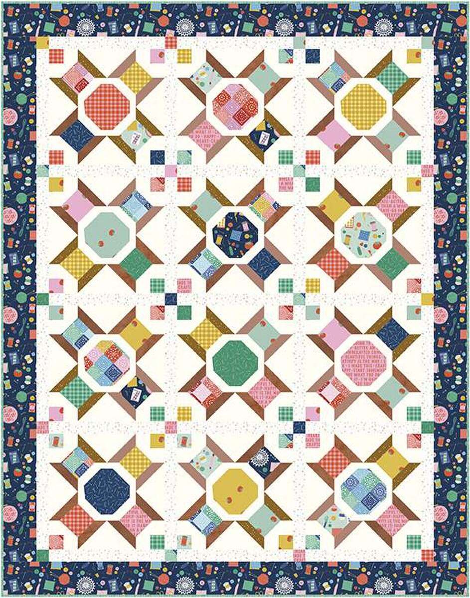 Vintage Spools Quilt Kit with colorful spool blocks and navy floral border by Amber Kemp-Gerstel for Riley Blake Designs