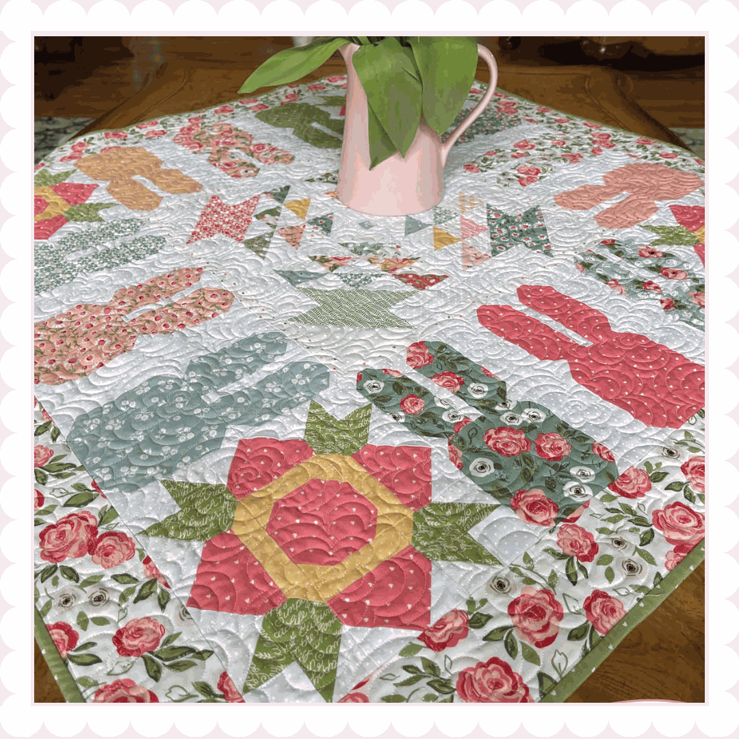 Ring Around the Bunnies quilt kit with scrappy spring blocks and floral borders in white, pink, and blue