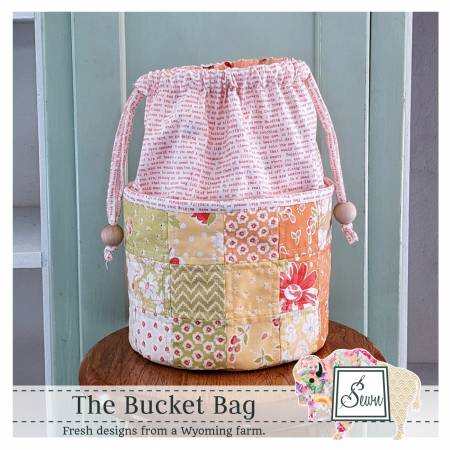The Bucket Bag quilted drawstring bag with patchwork design and flat bottom, perfect for crafters and sewists