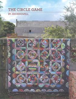 The Circle Game Quilt Pattern featuring 16 unique circular blocks in a striking layout for curved piecing skills