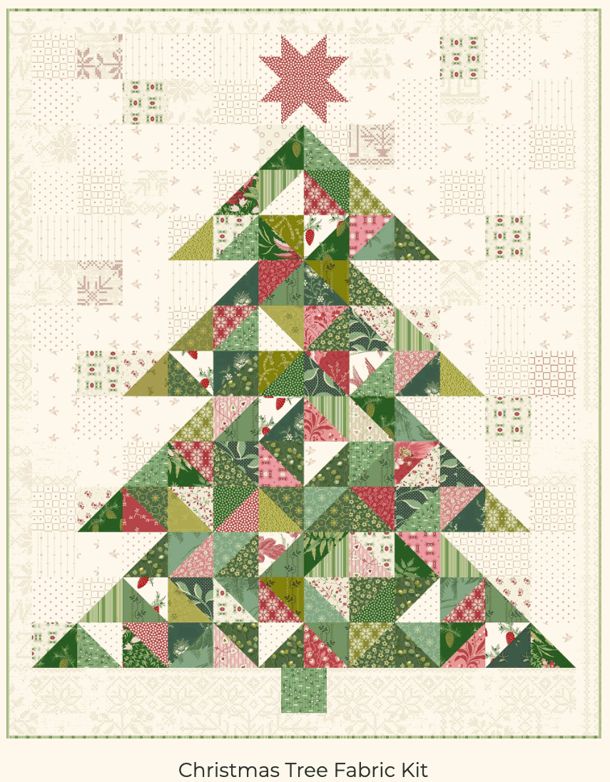 Christmas Tree Kit quilt top with Joy fabric from Andover featuring green and red patchwork tree design and star topper