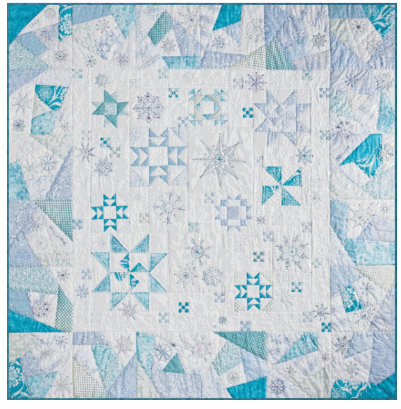 Snow Flurries Quilt Kit with embroidered and beaded snowflakes on a scrappy blue and white quilt background