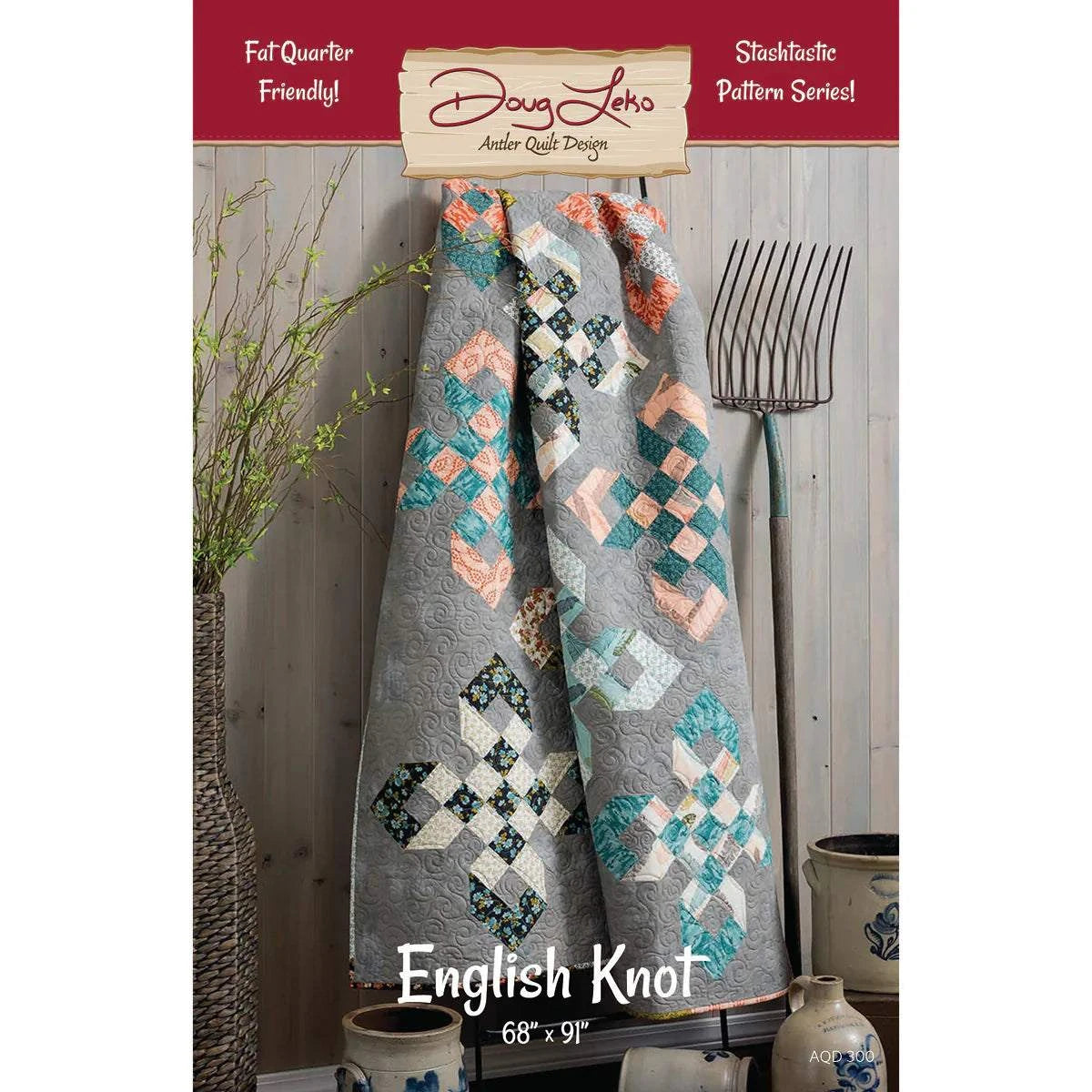 English Knot Pattern quilt hanging with colorful blocks on gray background by Doug Leko Fat Quarter Friendly design