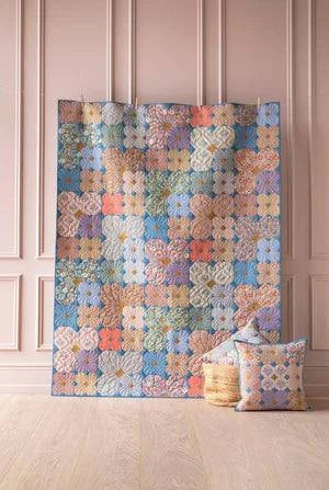 Wallflower quilt kit using Tilda fabric. multi color 4 petal flowers with a background using Prussian (blue).