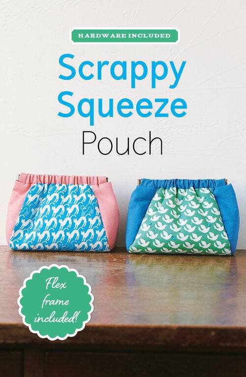 Two colorful Scrappy Squeeze Pouch fabric pouches with flex frames on a wooden surface
