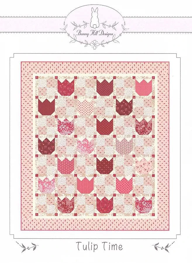 Tulip Time Quilt Pattern by Bunny Hill Designs showing pink and red tulip blocks on a 53.5" x 60.5" quilt design