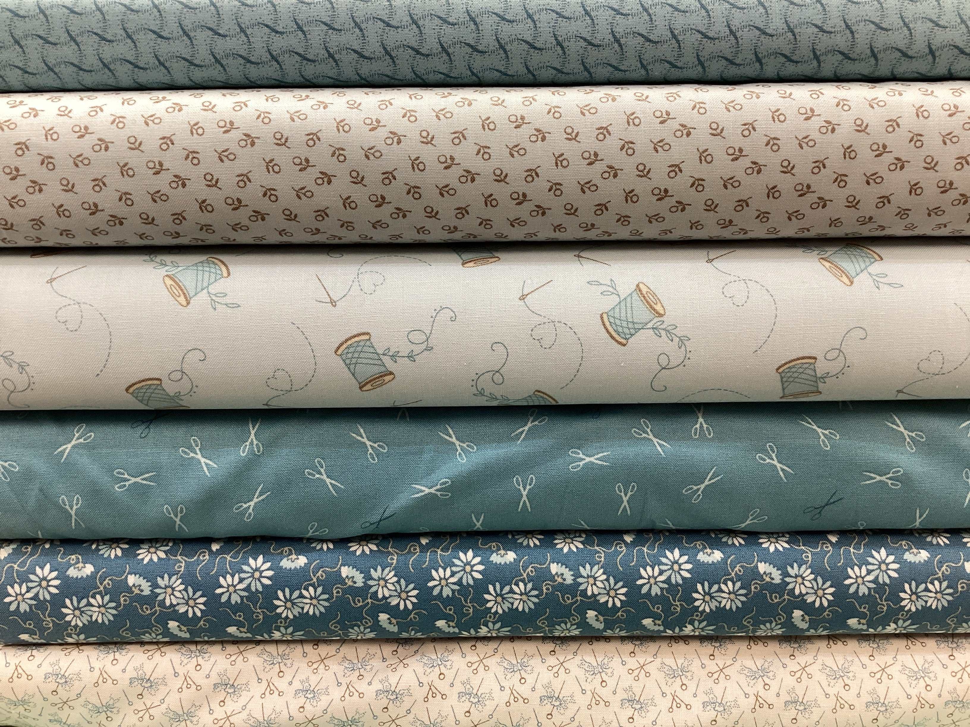 M50 Lucky Break Kit fabric bundle with sewing-themed and floral prints in muted blue and beige tones