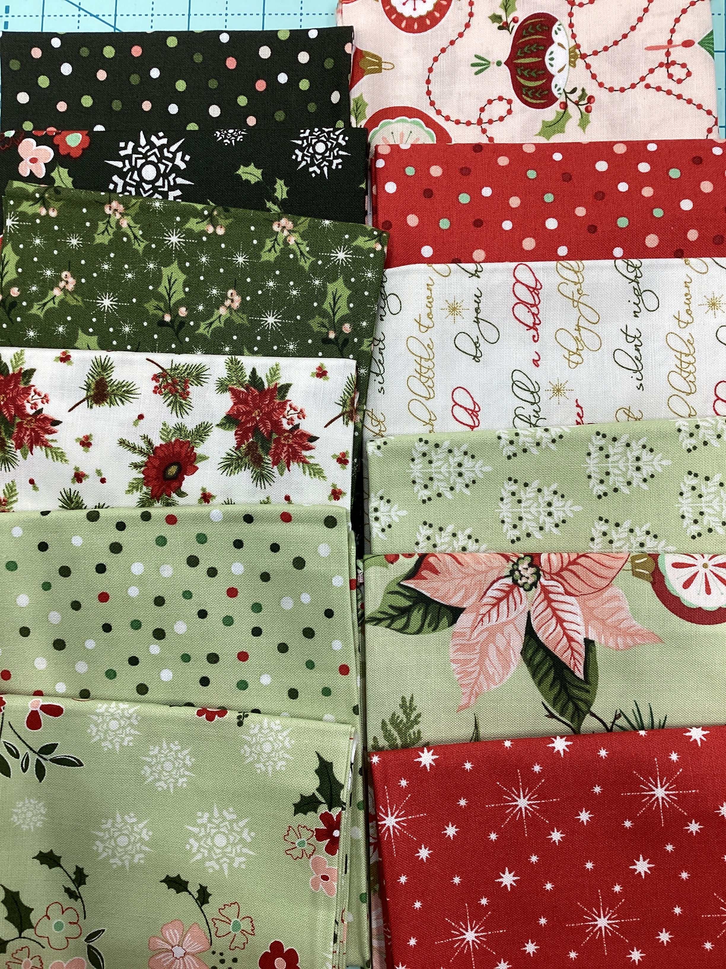 (12) Fat Quarter Bundle with assorted holiday-themed fabric designs curated by Bella Rose Quilts