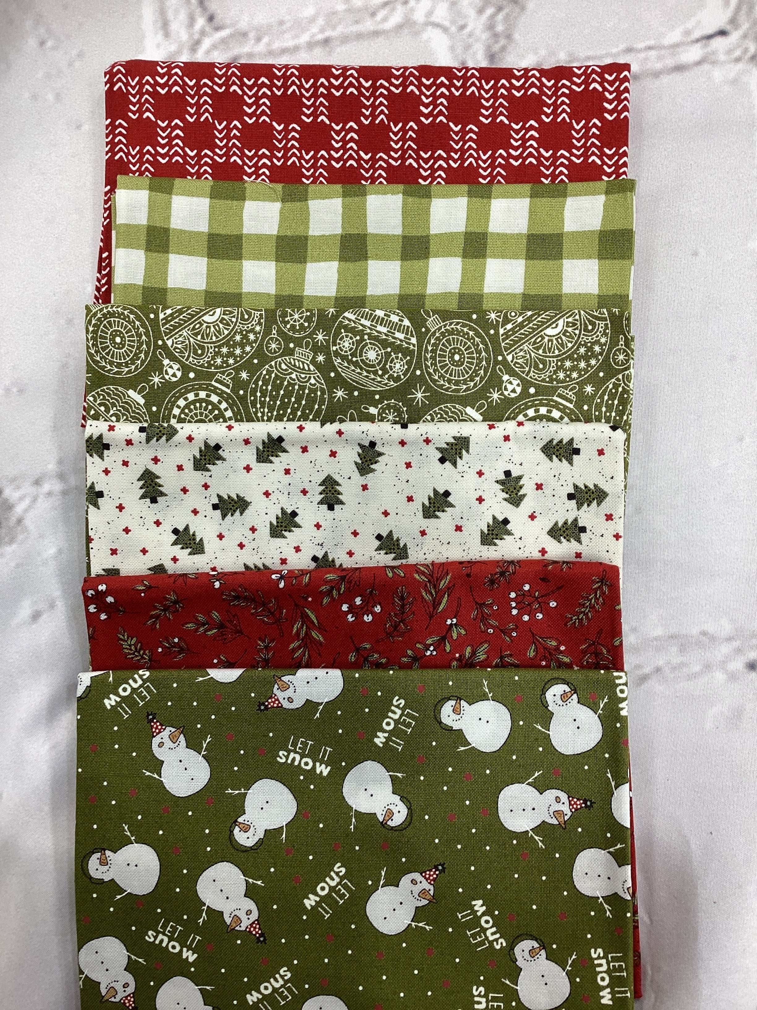M50 Starry Night fabric bundle with red, green, plaid, and snowman patterns curated by Bella Rose Quilts
