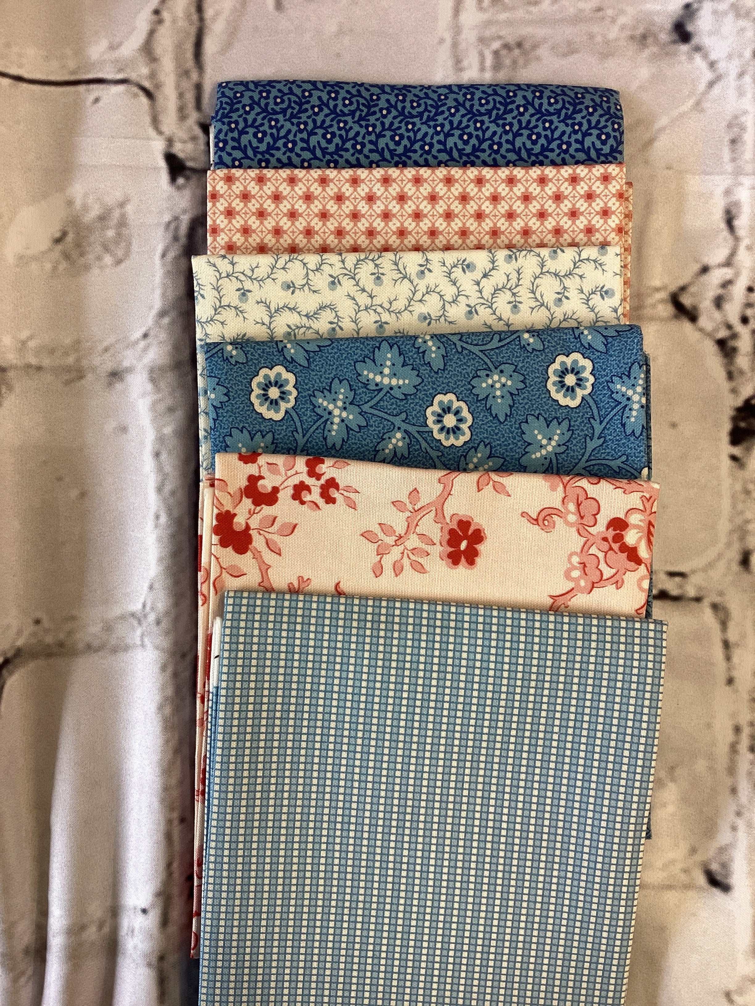 M50 Starry Night fabric bundle curated by Bella Rose Quilts with blue and red floral patterns