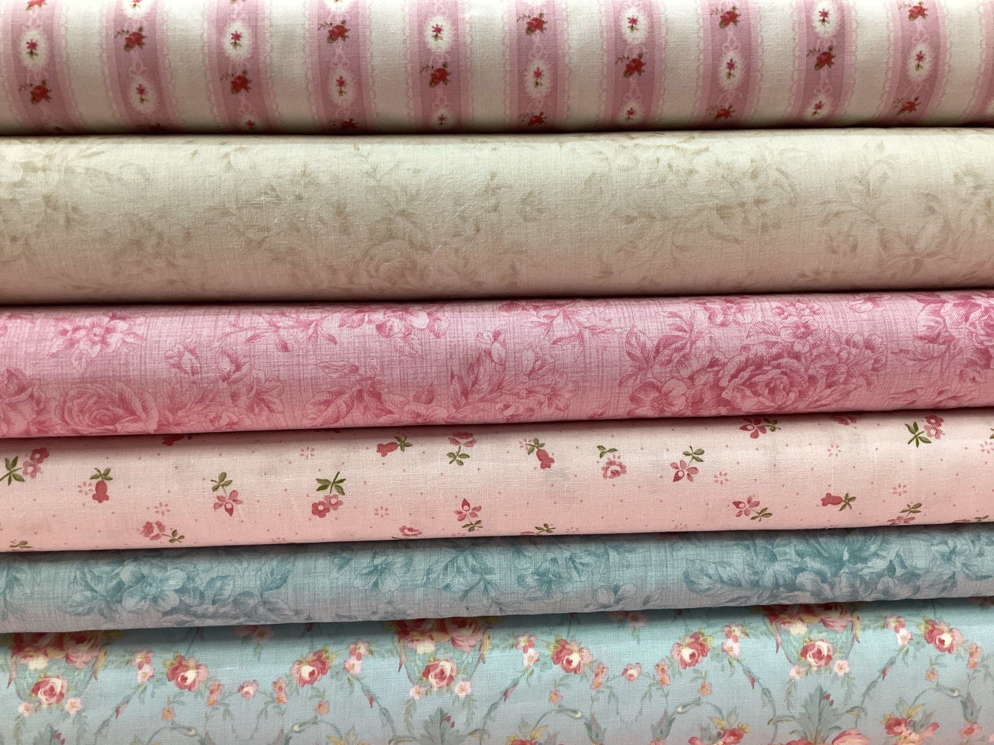 M50 Lucky Break Kit with pink, beige, and blue floral quilting fabrics stacked