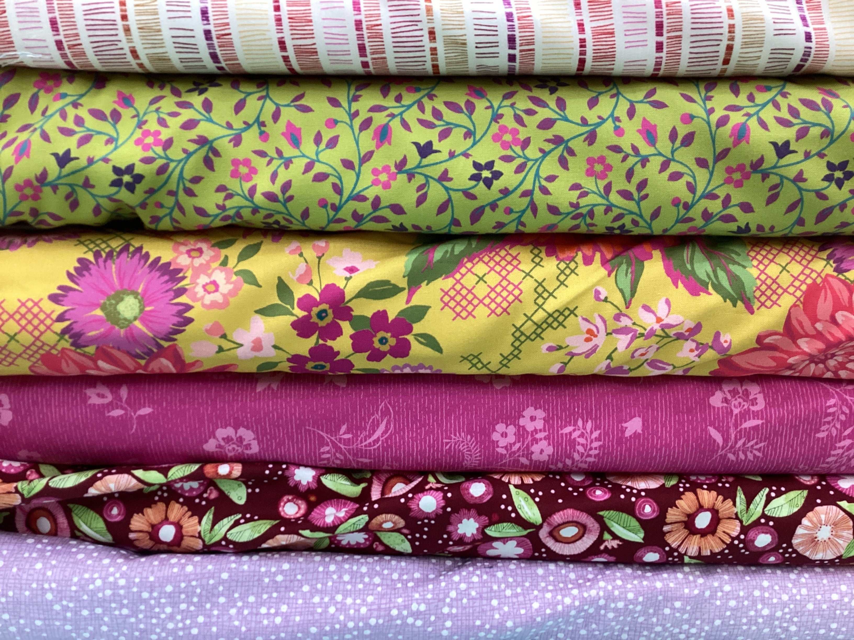 Stack of colorful floral and patterned fabrics in M50 Lucky Break Kit curated by Bella Rose Quilts